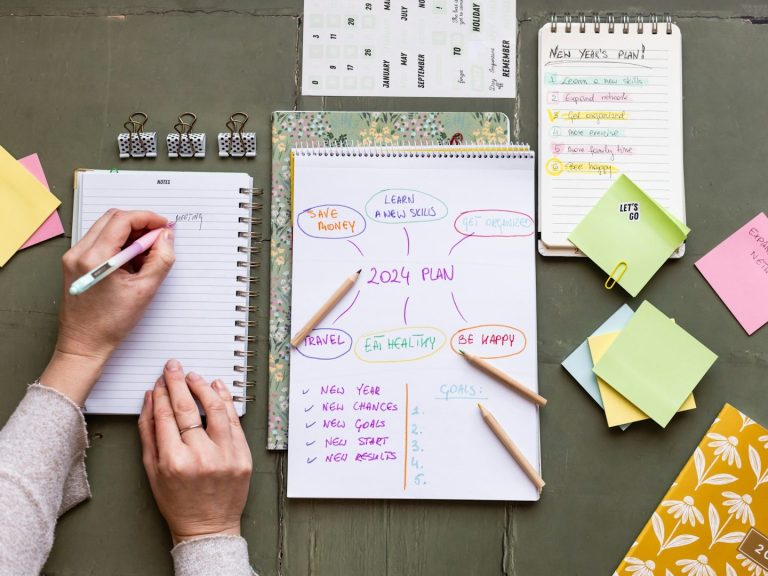 Sticky notes, note pads and a person taking notes to serve as a digital assistant.