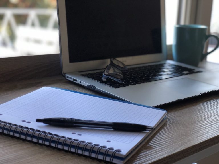 Some tools of a digital marketer: notebook, computer and coffee. Lot's of coffee.